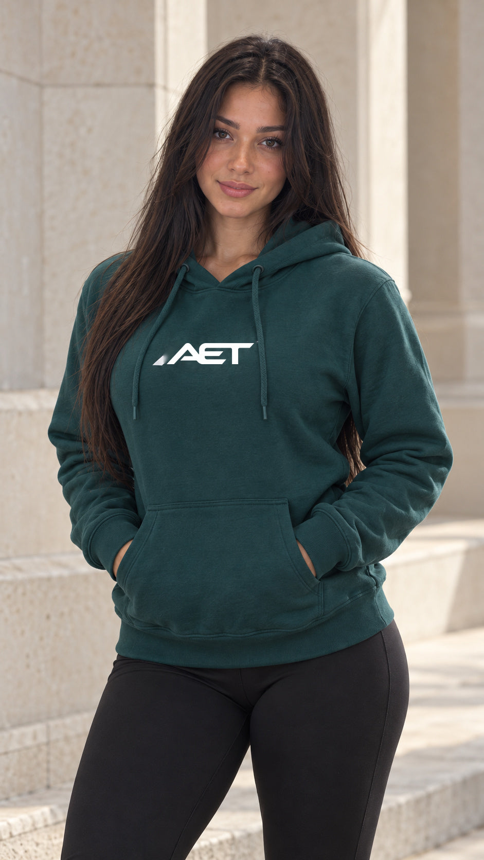 Mila Cruz wearing the AET Core Hoodie in sports green