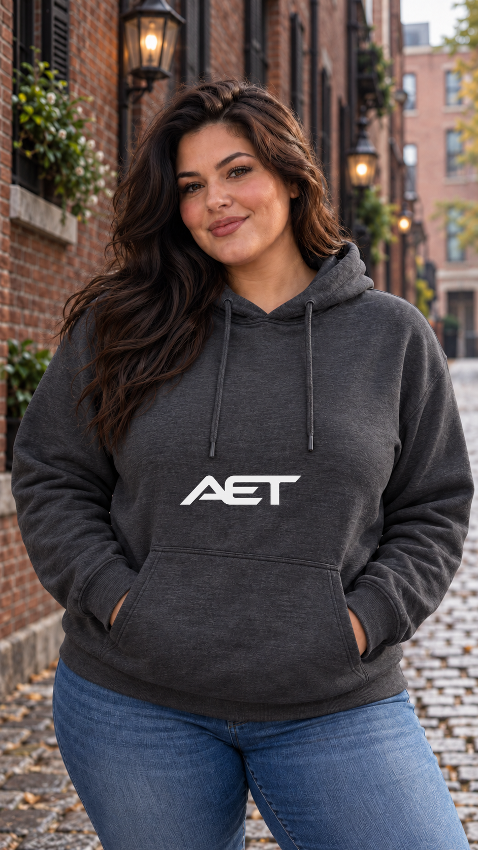 Valentina wearing the AET Core Hoodie in Dark Heather, featuring the connected AET wordmark.