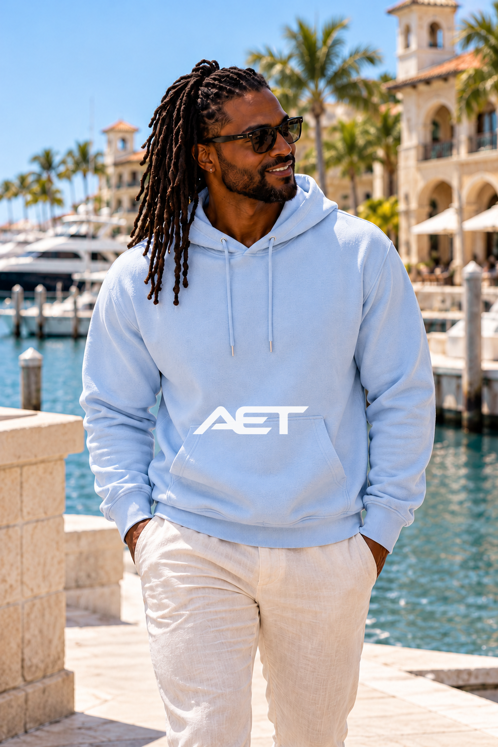 Kael wearing the AET Core Hoodie in Light Blue, featuring the connected AET wordmark.