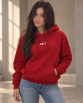 Mila wearing the AET Core Hoodie in a warm studio