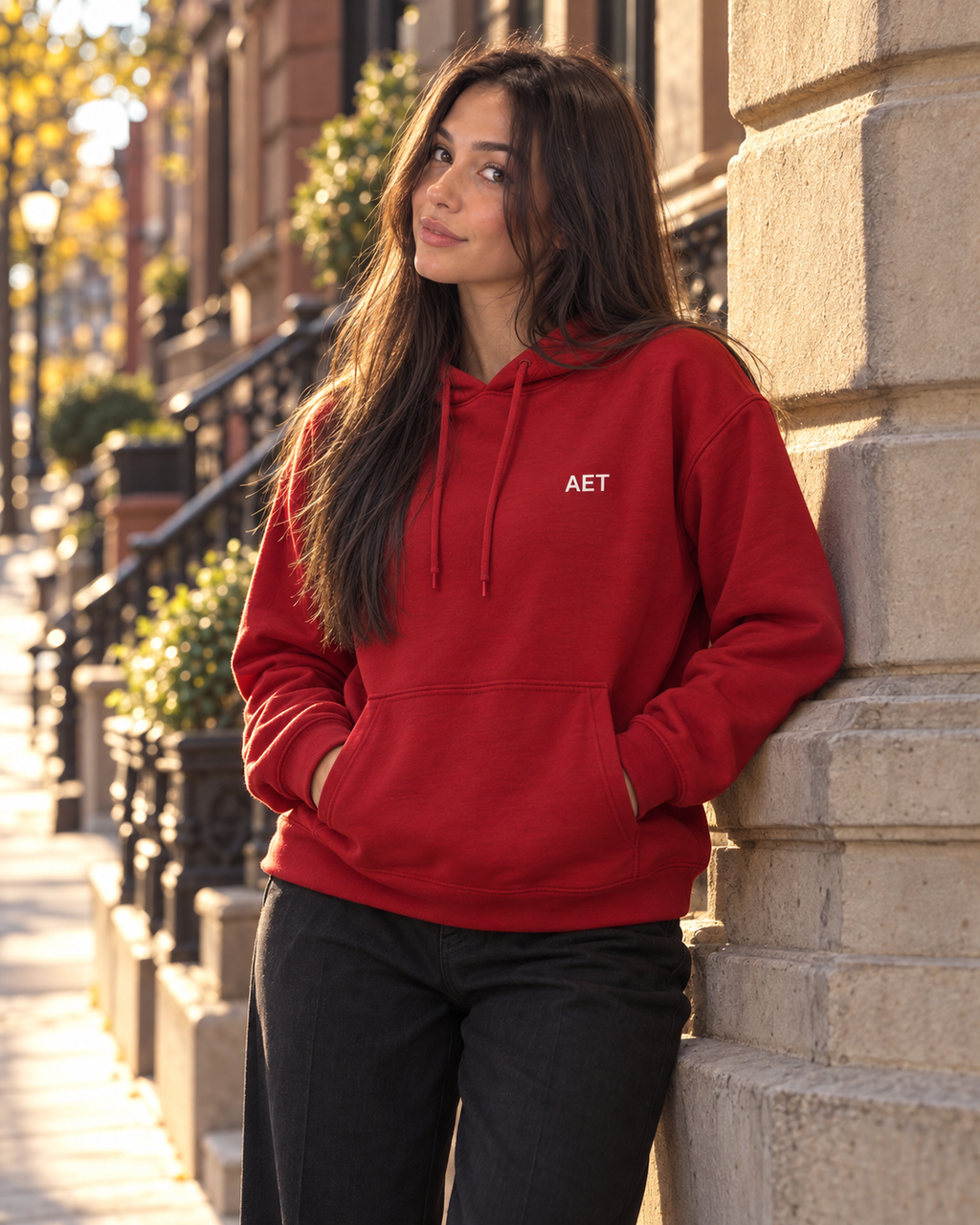Mila wearing the AET Core Hoodie on a Boston brownstone street