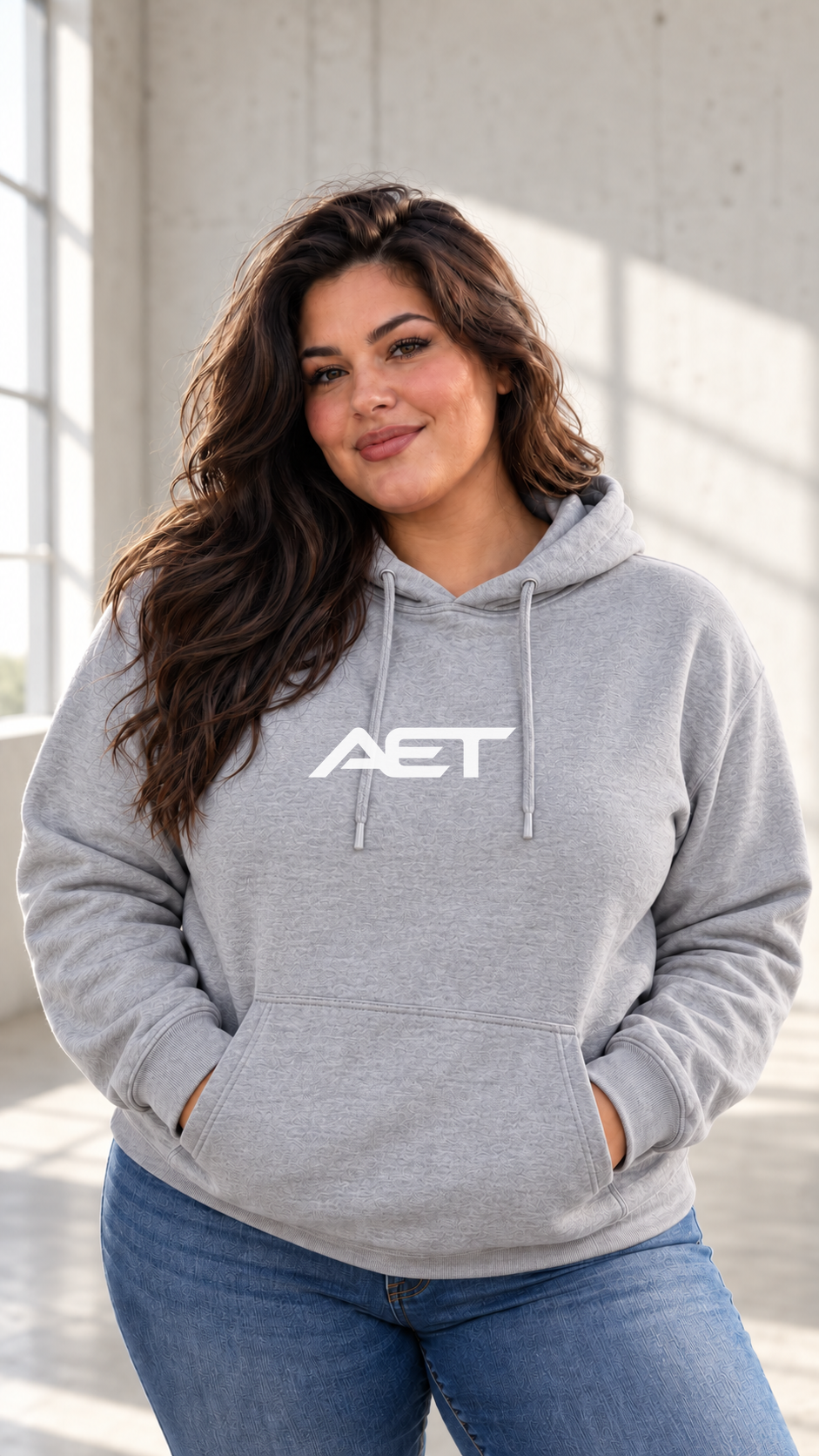 Kael wearing the AET Core Hoodie in Navy, featuring the connected AET wordmark.
